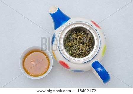 Top view of Glass teapot with Chinese tea on white blackground.