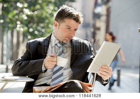 Businessman Sitting Outdoors In Coffee Break Using Digital Tablet Pad Checking Onl¡ne News