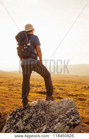 hiker with backpack traveling in Norway mountains Dovre