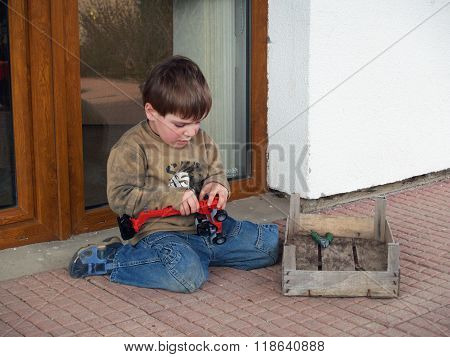 Boy repairing his toy-car