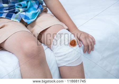 Child Injured. Wound On The Child's Knee With Bandage.