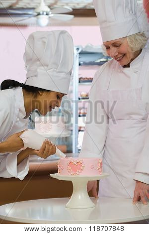 Baker decorating cake