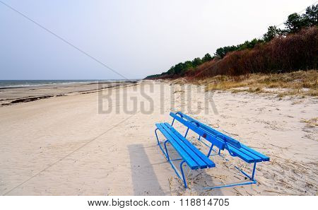 Blue bench at coastline of Baltic sia in Latvia