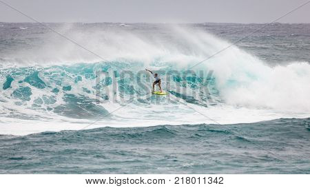 SUNSET BEACH HAWAII USA - DECEMBER 2, 2017: Surfer competing at the 2017 Vans World Cup of Surfing competition at Sunset Beach on Oahu's scenic North Shore. This is the second of three surfing competitions and Conner Coffin took first place.