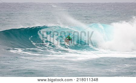 SUNSET BEACH HAWAII USA - DECEMBER 2, 2017: Surfer competing at the 2017 Vans World Cup of Surfing competition at Sunset Beach on Oahu's scenic North Shore. This is the second of three surfing competitions and Conner Coffin took first place.