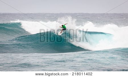 SUNSET BEACH HAWAII USA - DECEMBER 2, 2017: Surfer competing at the 2017 Vans World Cup of Surfing competition at Sunset Beach on Oahu's scenic North Shore. This is the second of three surfing competitions and Conner Coffin took first place.