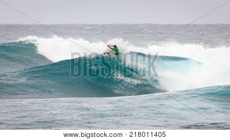 SUNSET BEACH HAWAII USA - DECEMBER 2, 2017: Surfer competing at the 2017 Vans World Cup of Surfing competition at Sunset Beach on Oahu's scenic North Shore. This is the second of three surfing competitions and Conner Coffin took first place.