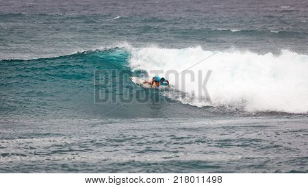 SUNSET BEACH HAWAII USA - DECEMBER 2, 2017: Surfer competing at the 2017 Vans World Cup of Surfing competition at Sunset Beach on Oahu's scenic North Shore. This is the second of three surfing competitions and Conner Coffin took first place.