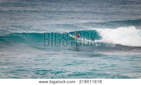 SUNSET BEACH HAWAII USA - DECEMBER 2, 2017: Surfer competing at the 2017 Vans World Cup of Surfing competition at Sunset Beach on Oahu's scenic North Shore. This is the second of three surfing competitions and Conner Coffin took first place.