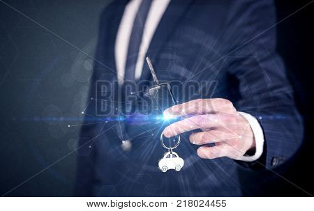 Businessman in suit holding over a key with connection concept around