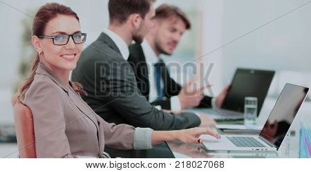 Portrait of happy business woman with  colleagues interacting on