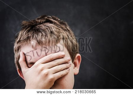 Student with stupid written on his forehead