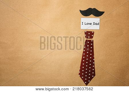 Composition with phrase I LOVE DAD for Father's Day on craft paper