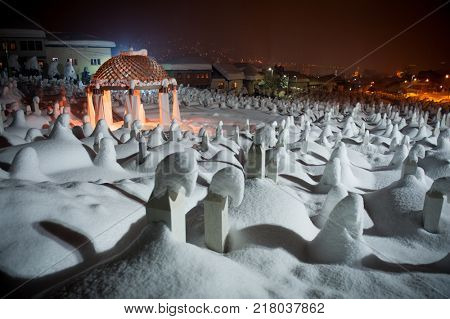 Mystical graveyard memorial in winter snow night