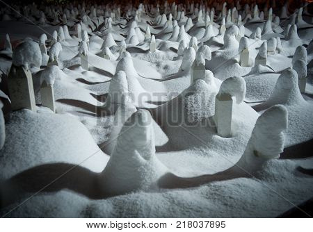 Mystical graveyard memorial in winter snow night