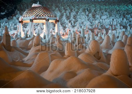 Mystical graveyard memorial in winter snow night