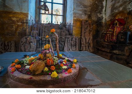 Shiva Lingam Temple Interior Ornate With Flowers And Colors With Majestic Light Coming From Window,