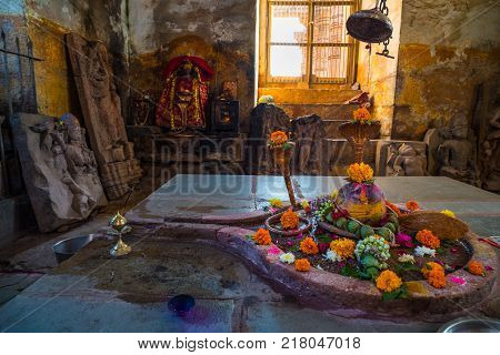 Shiva Lingam Temple Interior Ornate With Flowers And Colors With Majestic Light Coming From Window,