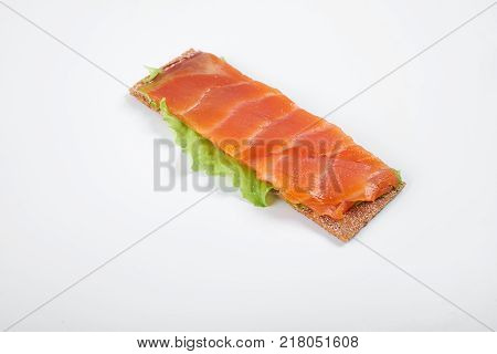 Low caloric open sandwich with red fish. Isolated on white background.