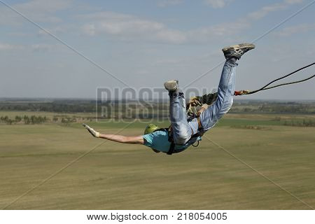 Belarus Gomel May 06 2017.Jumping with a rope.Extreme man jumping from a huge height.Jumping with a rope.Flight down on the rope.Engage in ropejumping.Dangerous hobbies