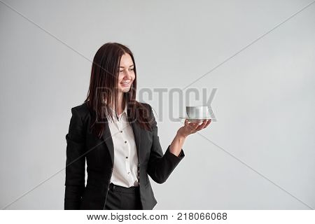 office worker offering you a cup of coffee or tea over white background.