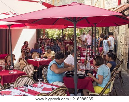 Ajaccio Corsica. France August 17 2017: Group of people eating outside a restaurant in the center of Ajaccio