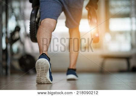 Sport, Bodybuilding, Lifestyle And People Concept - Young Man With Steel Weights Flexing Muscles And