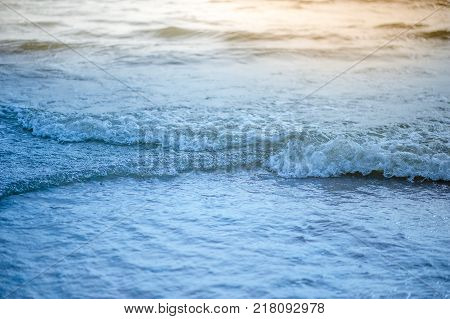 Soft Wave Of Blue Ocean On Sandy Beach. Background. Selective Focus.
