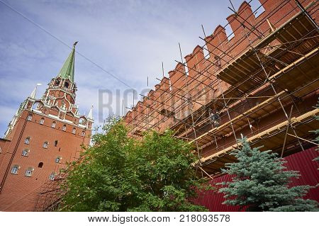MOSCOW, JUN. 29, 2017: View on Moscow Kremlin Red Square red brick walls under construction. Construction worker. Moscow red square towers walls under construction. Building construction works