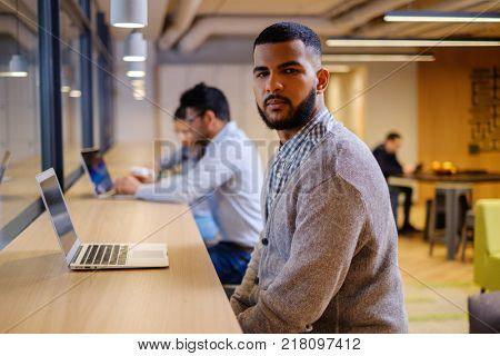 Young independent speacialists in coworking office.