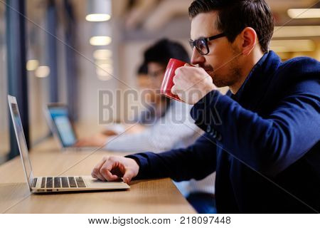 Young independent speacialists in coworking office.