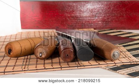 Chinese knives collection on a bamboo mat. View from above