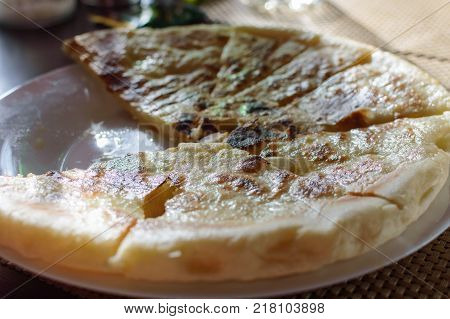 Hychin bread pie with potato stuffing. Traditional Caucasian cuisine - hot Ossetian pie.