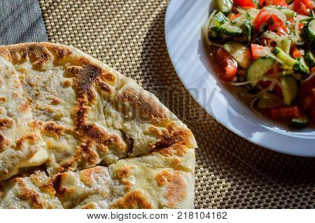 Hychin bread pie with potato stuffing. Traditional Caucasian cuisine - hot Ossetian pie.