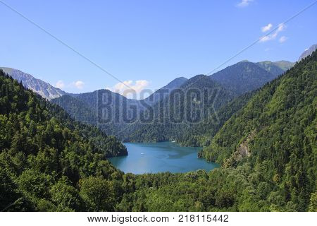 Beautiful panorama of natural mountain landscape. Blue Lake Ritsa among mountains of the Caucasus, Abkhazia. Ritz Park