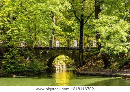 Ancient stone bridge in the autumn National Dendrology Park of Sofiyivka Uman Ukraine.
