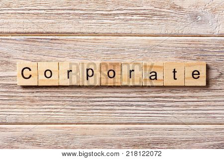 Corporate word written on wood block. Corporate text on table concept.