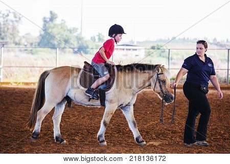 Ber Yakov, Israel - September 21, 2016: Horse riding lessons for kids. The boy on the horse