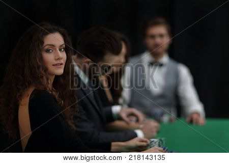 luckiest woman on the background of the players in the casino.