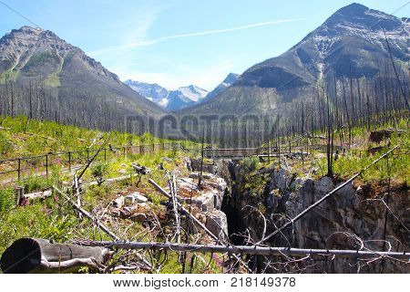 Foot bridge across Marble Canyon in Kootenay National Park British Columbia Canada near Banff with Mount Whymper and Vermilion Peak in the background