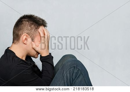 A Man Hammers A Nail Into Plaster Wall Under The Wallpaper