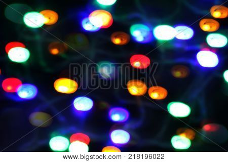 Bokeh of multicolored highlights on a black background.