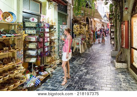 RETHYMNO CRETE - SEPTEMBER 20: Woman watching the merchandise in front of the shops at old town of city Rethymno on September 20 2017 in Crete