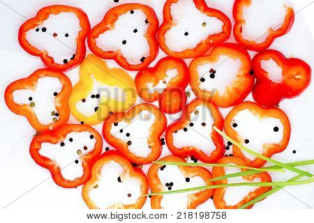 Sliced bolgarian paprika red and yellow pepper and black pepper peases