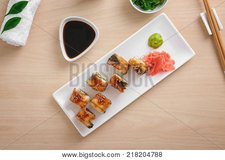 Composition with tasty sushi rolls on table