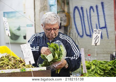 TEL AVIV , ISRAEL - 21 NOVEMBER 2017: Sellers on the old grocery street Nahalat-Benjamin