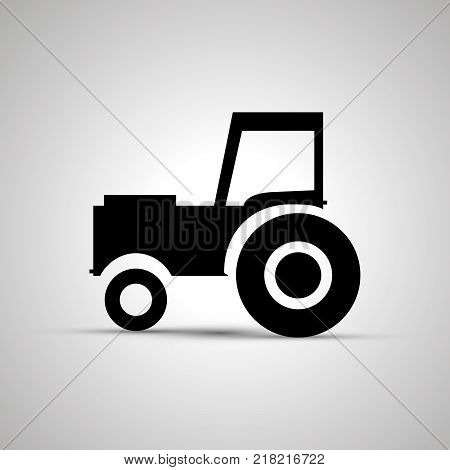 Tractor silhouette, side view simple black icon with shadow