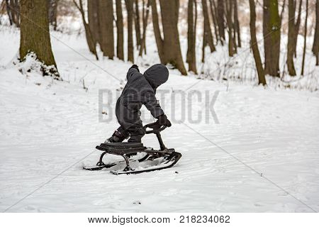 Boy And Snow Racer In Winter