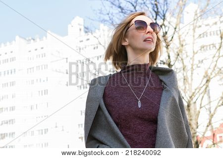 Portrait of a Woman in a Coat and Glasses