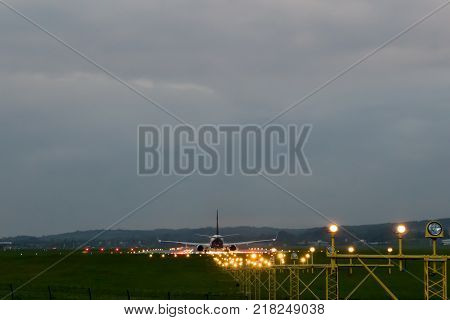 Airplane rides on the runway, security lights